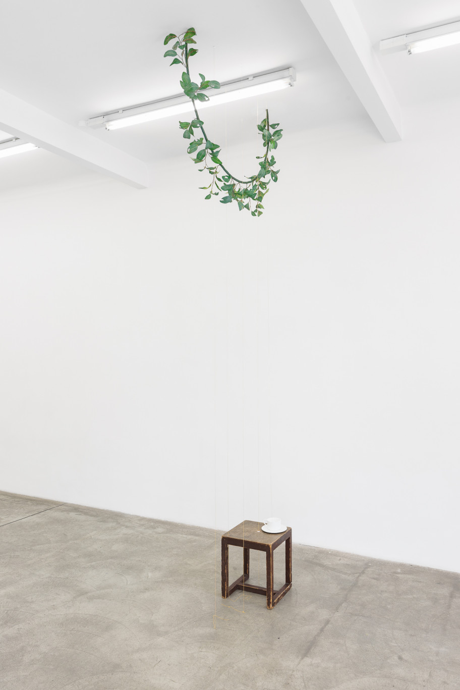 Tania Pérez Córdova A drip in a room in a house , 2023 iron, epoxy clay, plastic, acrylic, patterns of leaf damage, gold plated brass chains, found wooden stool, cup overall dimensions vary with the installation 