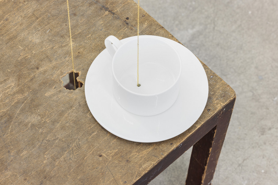 Tania Pérez Córdova A drip in a room in a house (detail), 2023 iron, epoxy clay, plastic, acrylic, patterns of leaf damage, gold plated brass chains, found wooden stool, cup overall dimensions vary with the installation 